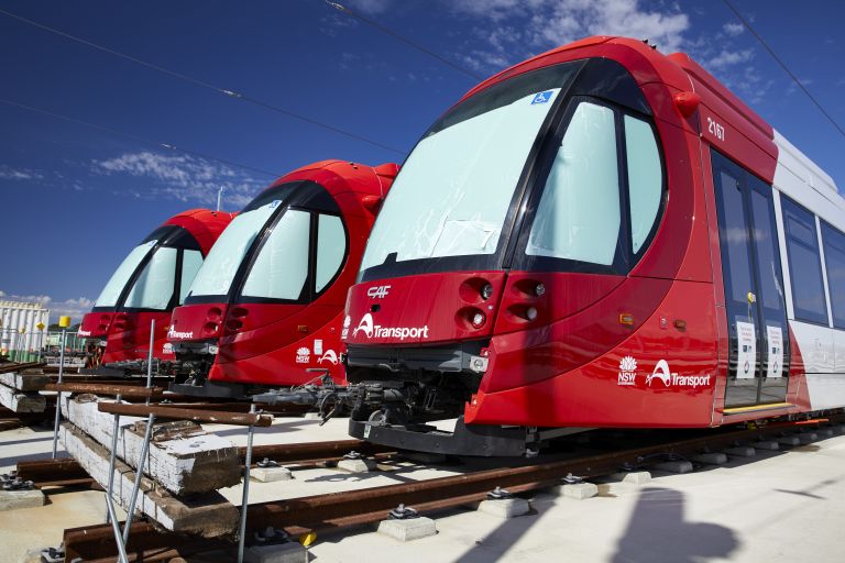 A shot of a fleet of the new 'Urbos 100' light rail trains set against a clear blue sky