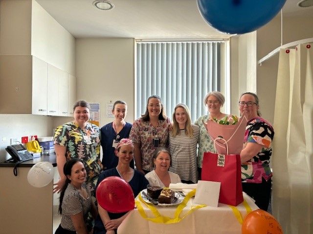 Maternity staff pictured with pregnant woman at a baby shower event