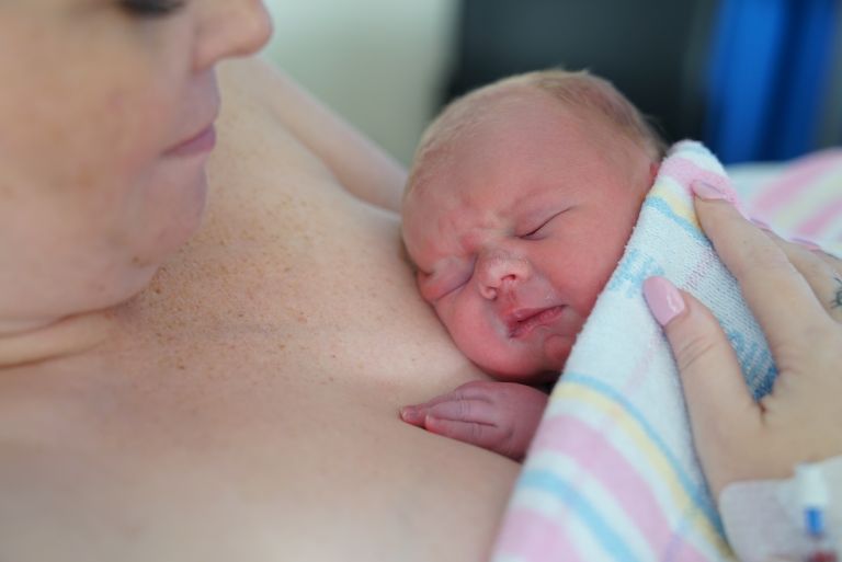 Newborn baby on mother's chest