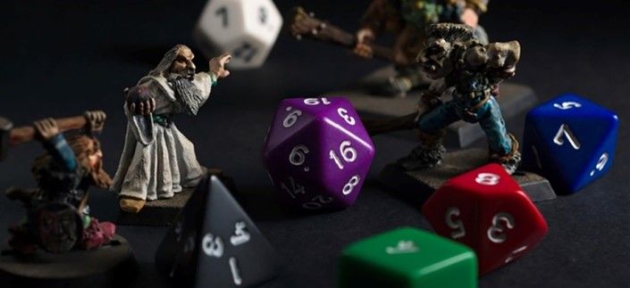 Dungeons and dragons figurines surrounded by dice