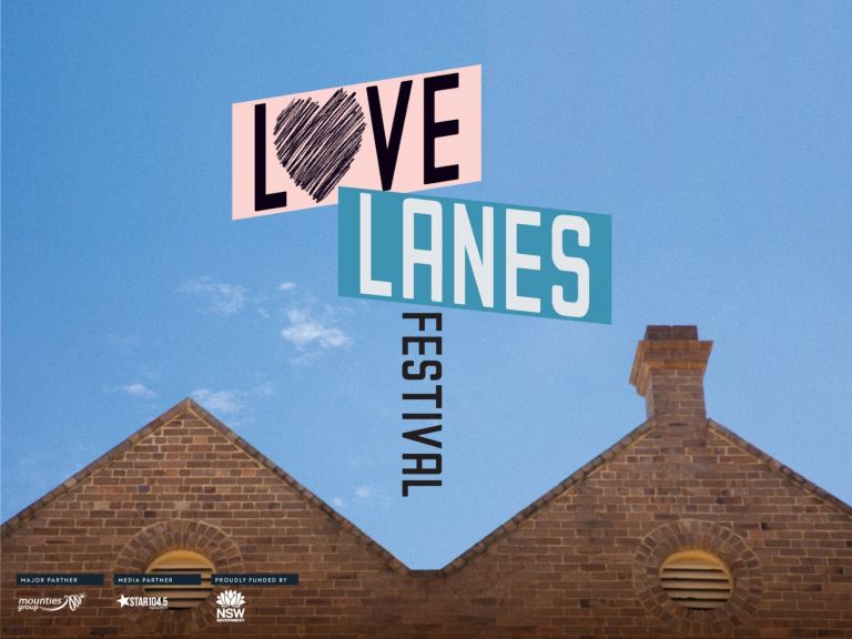 Love Lanes Logo above building facade with blue sky