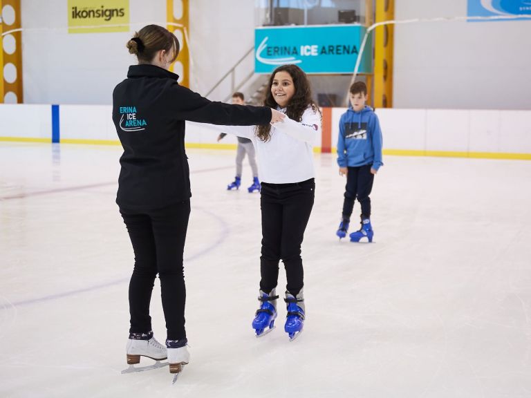 Erina Ice Arena staff member giving tips to a new skater.