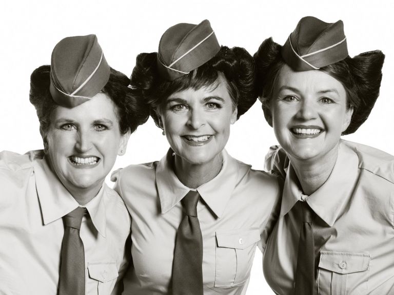 Three women dressed as The Andrews Sisters