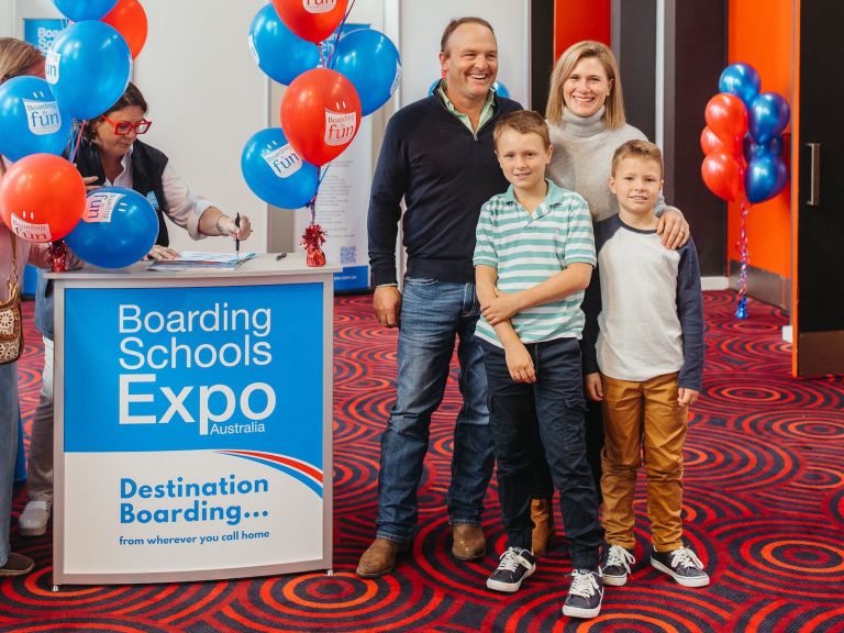 Family at the entrance of Boarding Schools Expo
