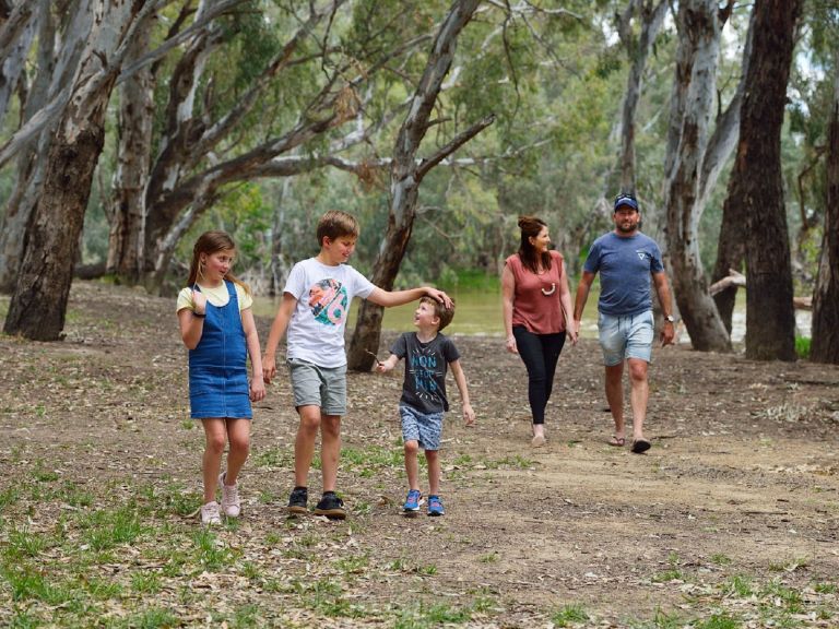 Family walking through bushland riverwalk
