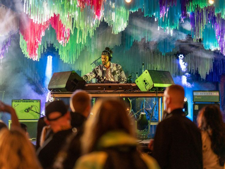 DJ playing a set on stage at FUSION