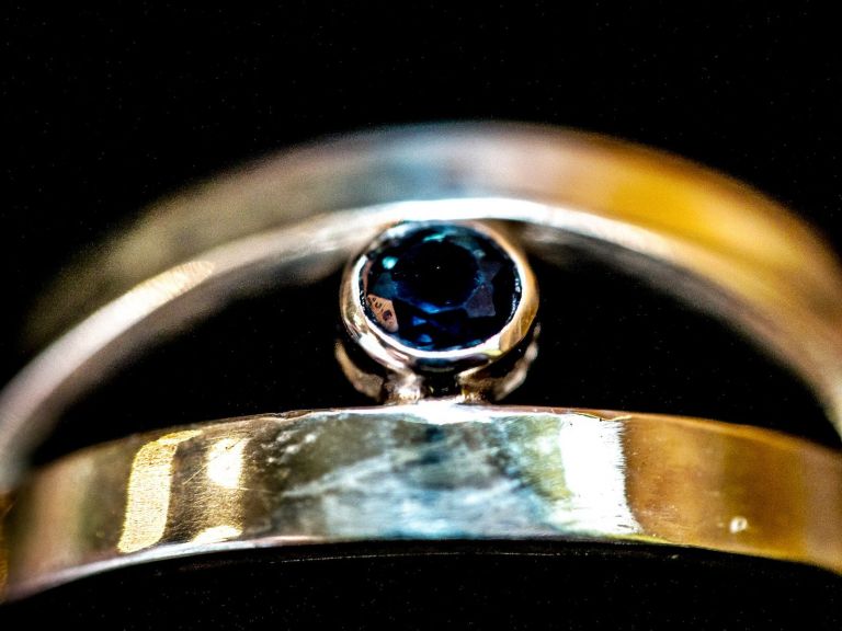 Bezel-set blue sapphire in a sterling-silver ring
