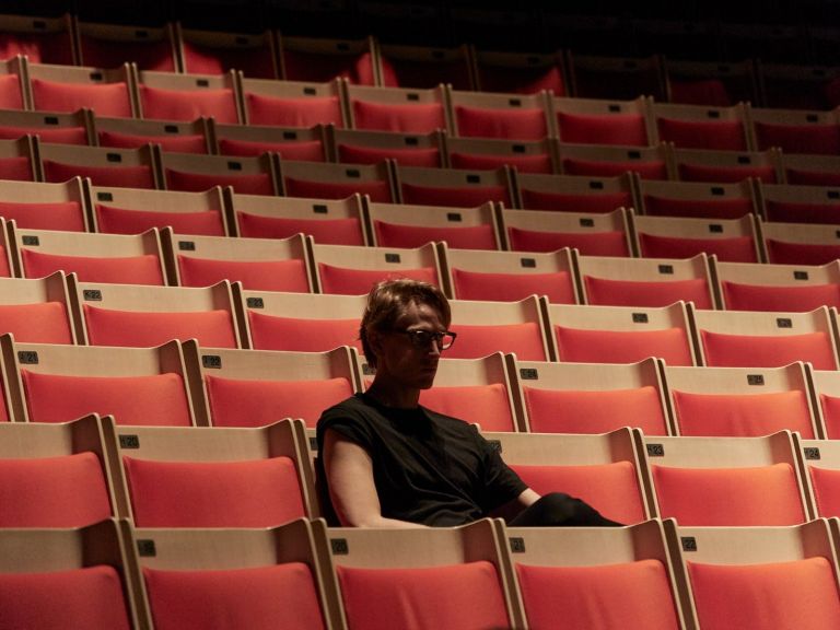 Artistic Director David Hallberg sitting alone in the audience at the Sydney Opera House.