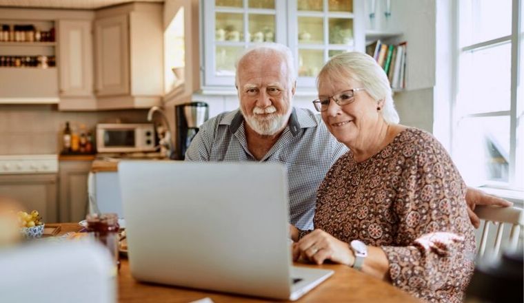 A senior couple booking tickets online