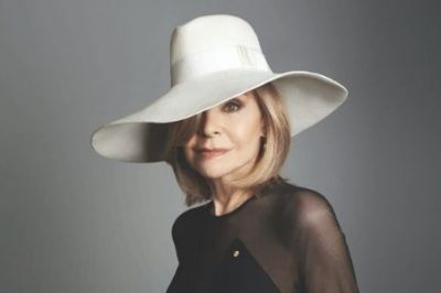 Headshot of Carla Zampatti in a black dress and white hat