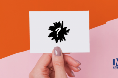 hand holding black drawing of a brain over a pink and orange background 