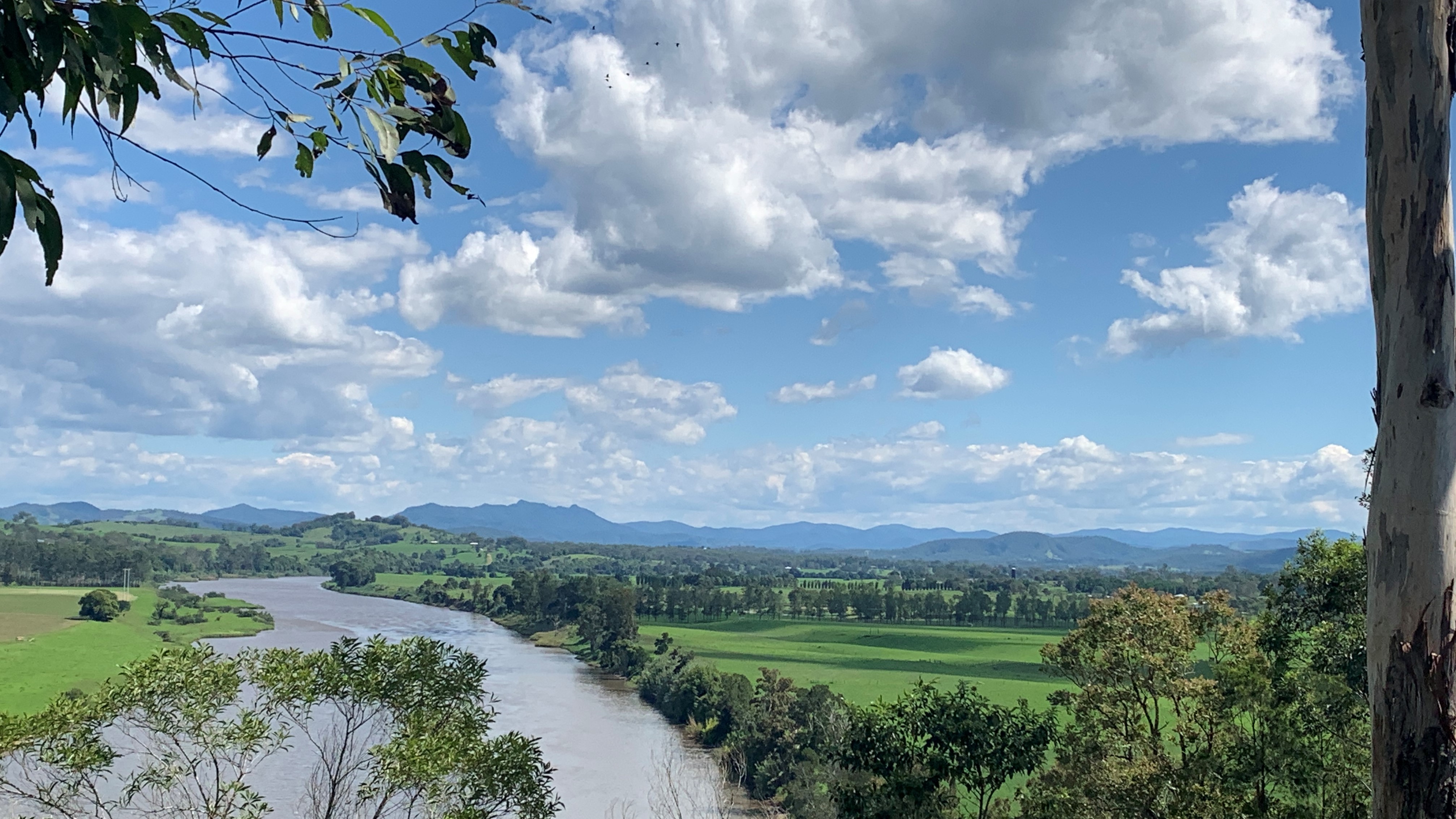 River through pastures in Mid Coast NSW, blue sky and clouds