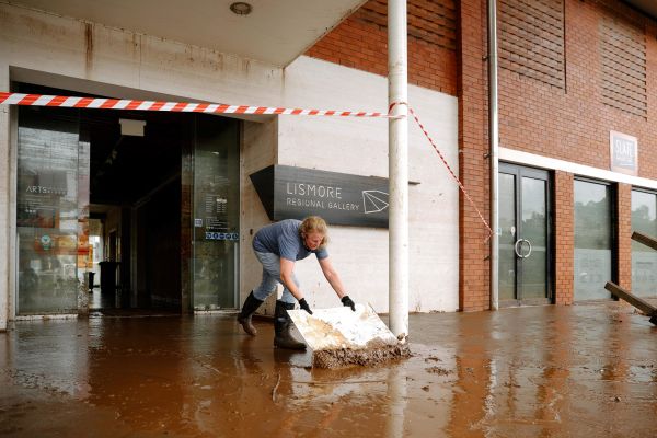 Cleaning up after flood outside Lismore Regional Gallery
