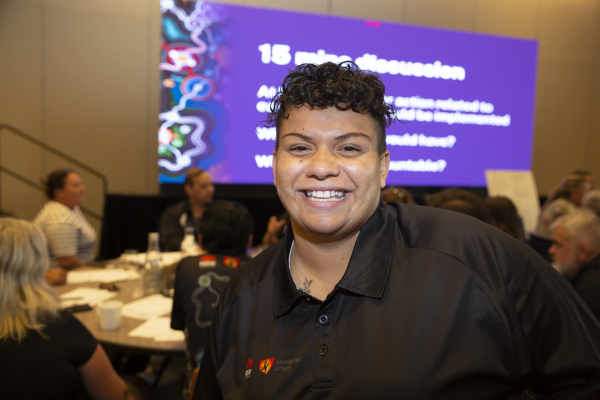 A head shot of a smiling Aboriginal Affairs staff member at a conference