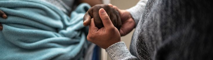 Holding hands with person unwell in hospital