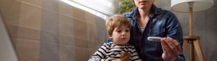 Mum with toddler checking thermometer