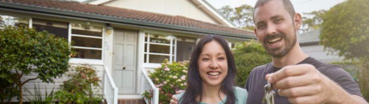 first home buyers holding up the keys to the house