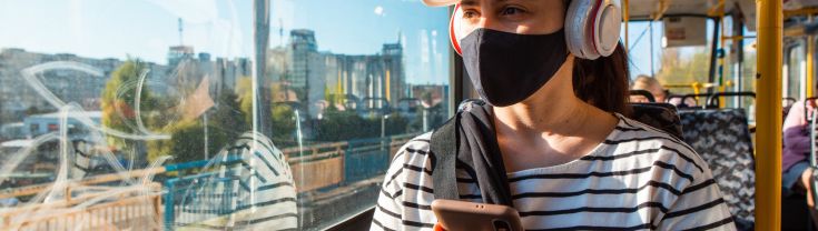 Woman on tram wearing a mask
