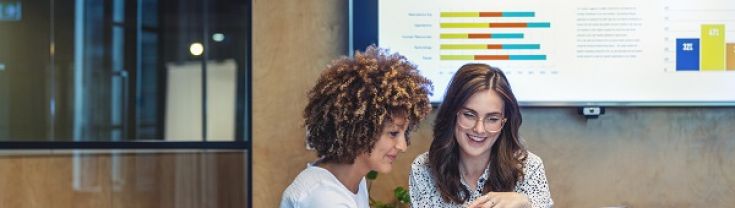 Two women looking at a laptop