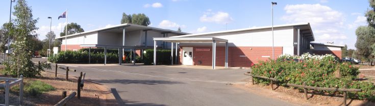 Main entrance access to the West Wyalong Health Service. The driveway runs along the left of the health centre, the ambulance entrance sits within a smaller building to the centre's right, the driveway continues down toward car parking spaces, which is not shown in the image. The main entrance on the right after the ambulance entrance.