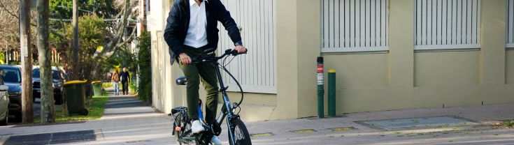 Man riding e-bike over bike path crossing