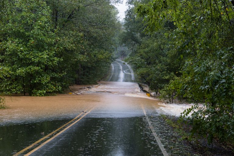 Floodwater flowing across a road