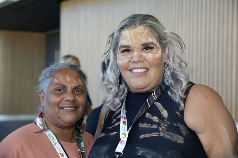 Two aboriginal woman smiling at the camera